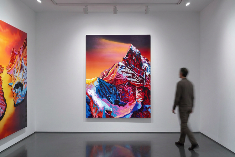 
Gallery view with both paintings slightly smaller on their walls and a blurred visitor approaching